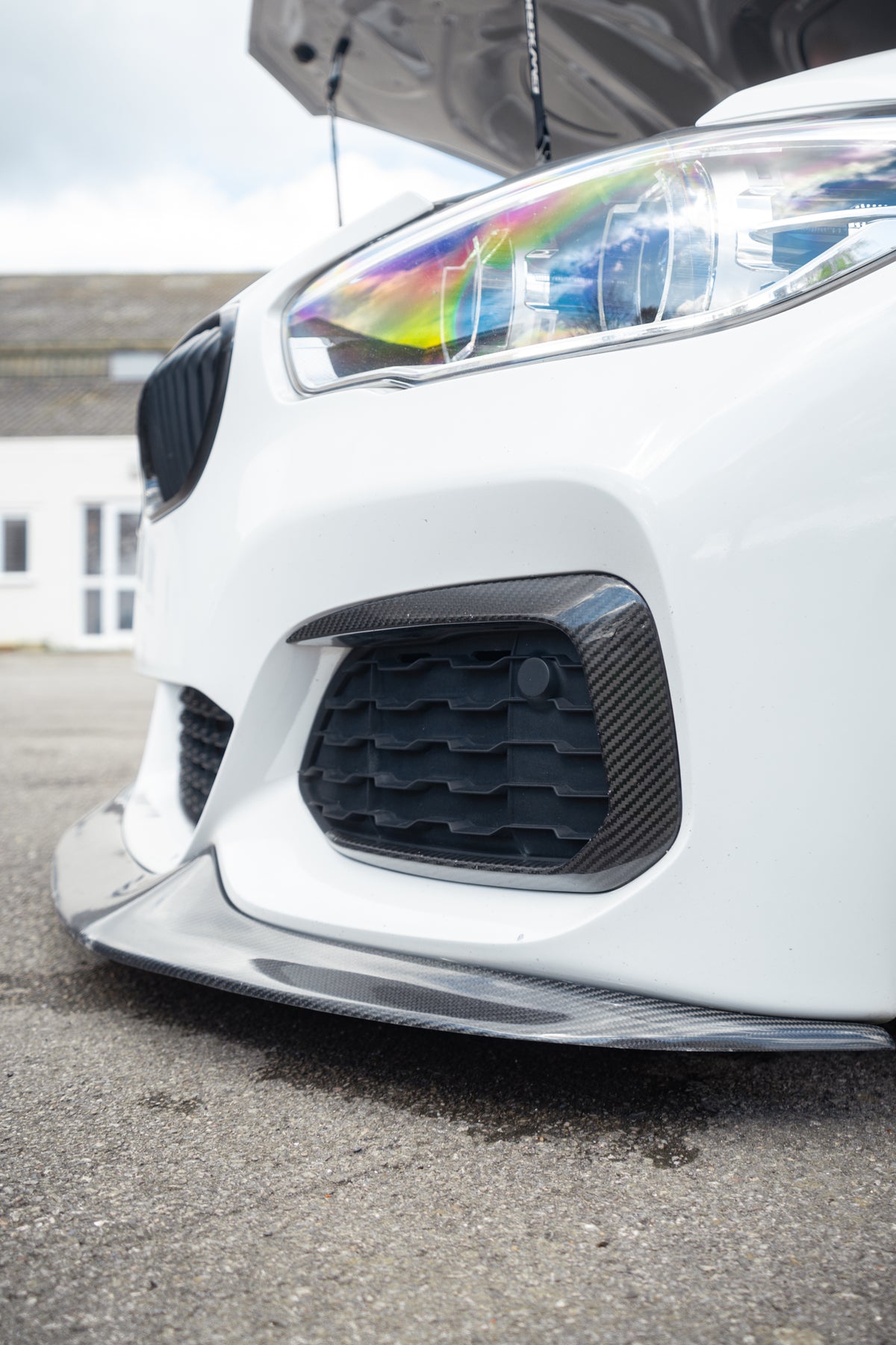 BMW M140i M135i carbon front bumper canards by 72Design on F20/F21 LCI model, close-up of aerodynamic canard details.