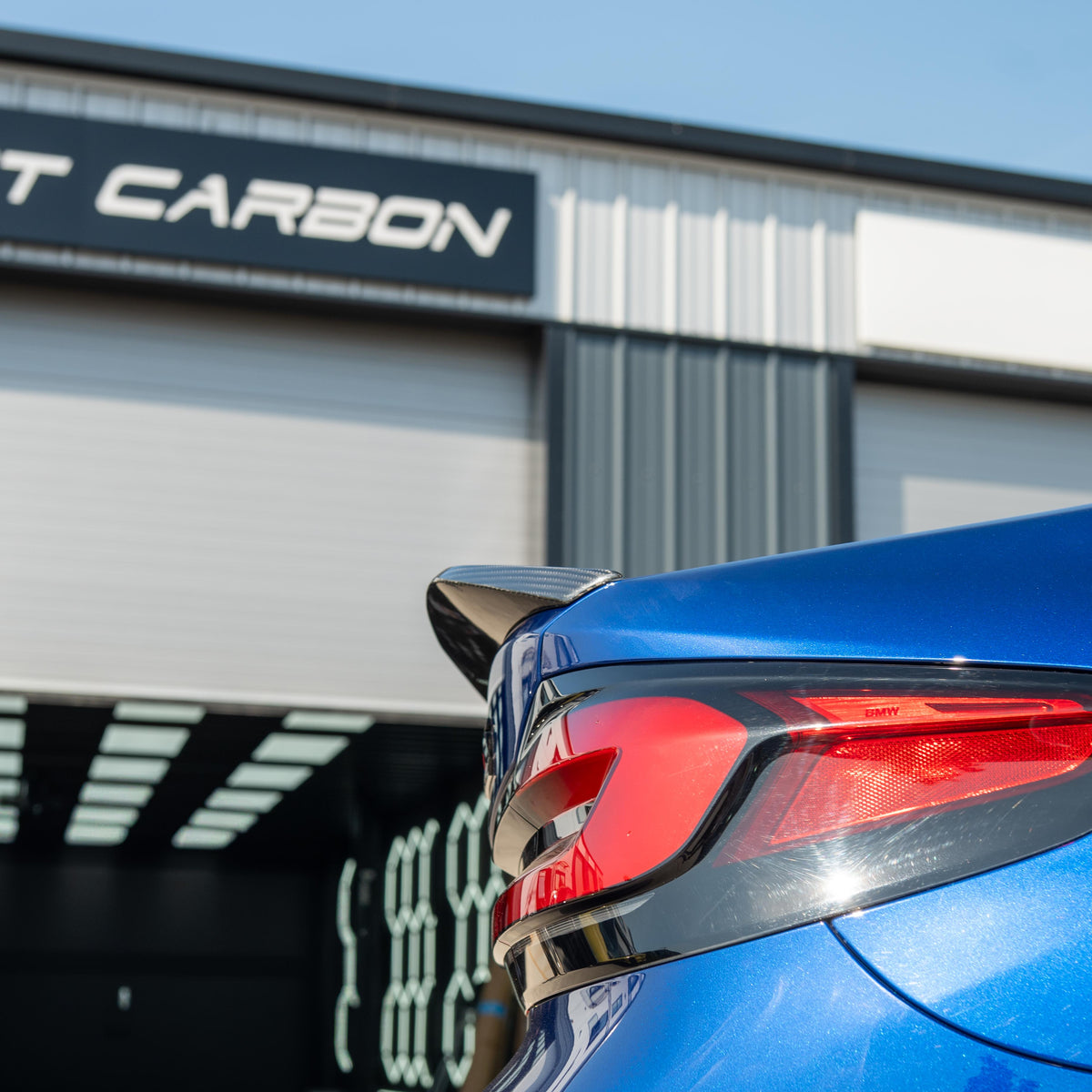 BMW M5 F90 and G30 5 Series carbon fiber spoiler by CT Carbon, showing sleek aerodynamic design on a black car.