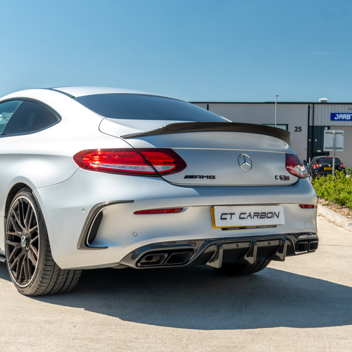 CT Carbon diffuser for Mercedes W205 C63 coupe, showing black carbon fiber with aerodynamic design and mounting details.