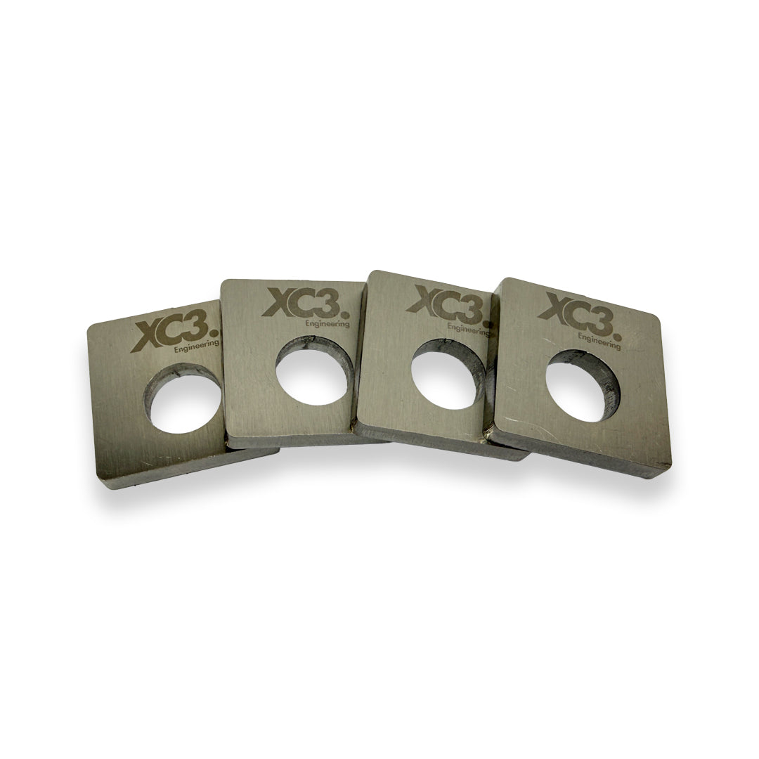 BMW M3 E9X E92 camber lockout shims for suspension alignment by XC3 Engineering, showing the metal shims used for camber adjustment.