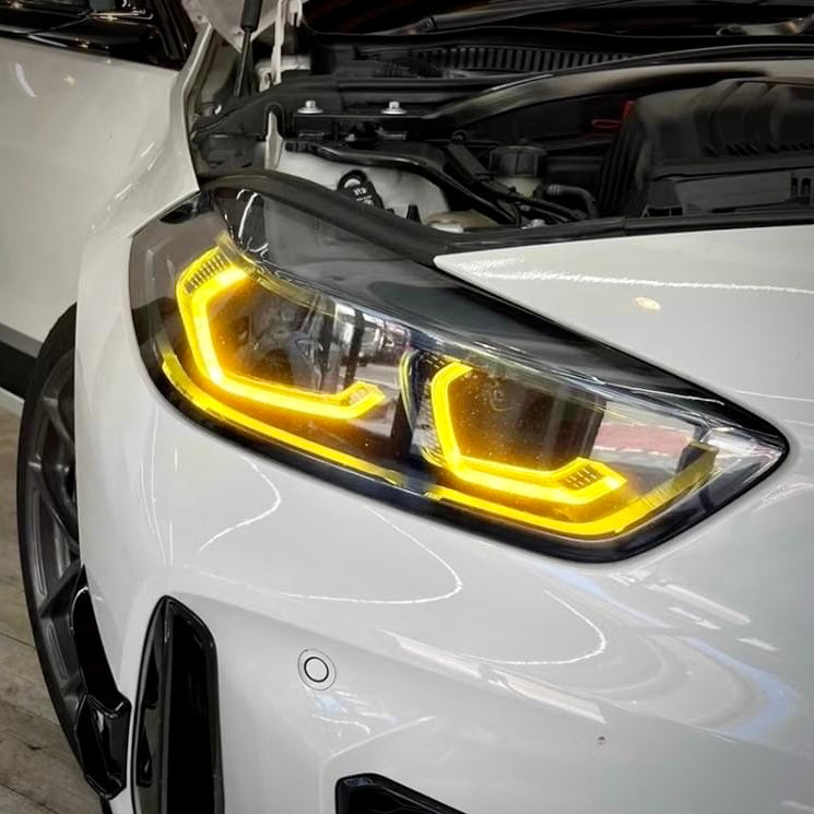 BMW F40/F44 2019-2024 M-SPORT yellow adaptive LED daytime running light module set by CT Carbon, shown in close-up.