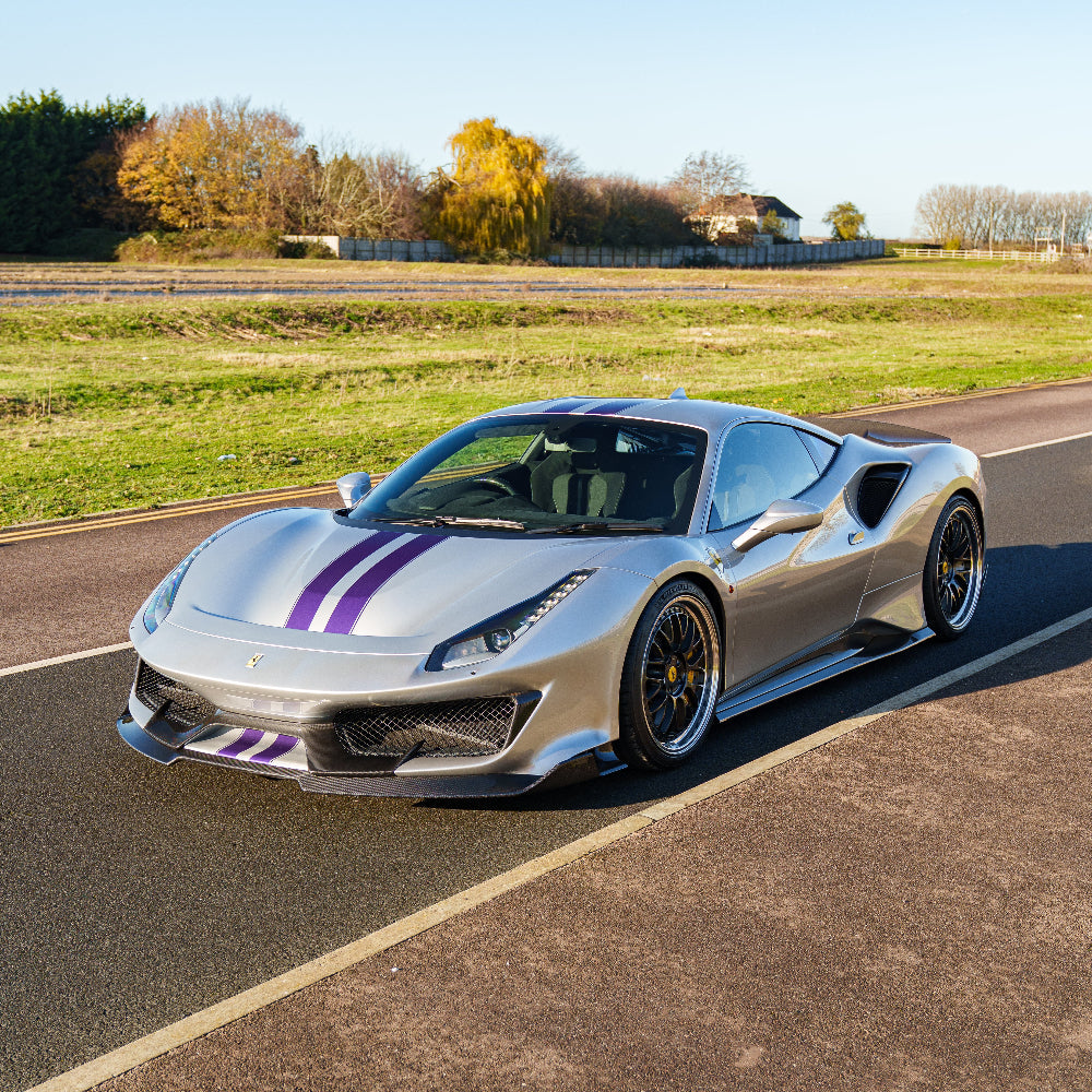 Ferrari 488 Pista carbon fibre splitter by CT Carbon, showing sleek aerodynamic design and detailed carbon fibre texture.