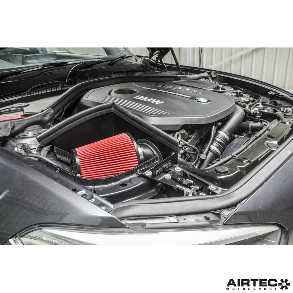 Airtec Motorsport induction kit installed in a BMW M140i/M240i, showcasing high-performance air intake components and hoses.