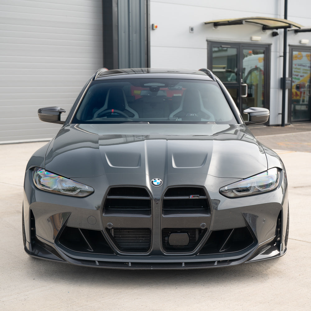 BMW M3 M4 G80 G81 G82 G83 carbon fibre grille by CT Carbon with ACC, showcasing sleek, textured carbon fiber design.