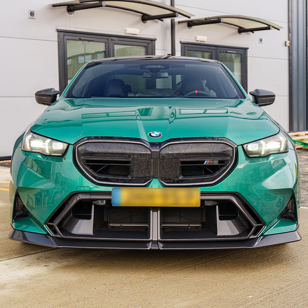 BMW G90 G99 M5 Touring 2024 carbon fibre front bumper middle trim by CT Carbon, shown in green on the car.