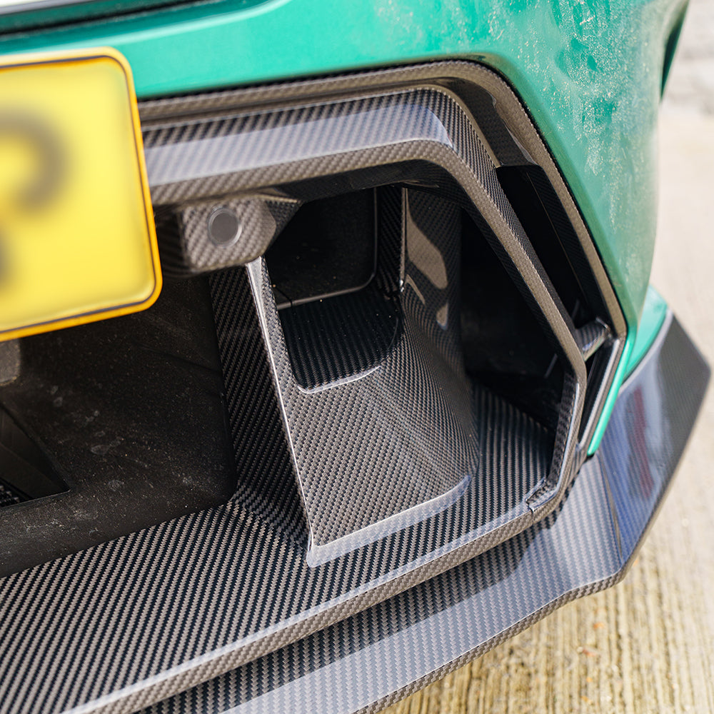 BMW G90 G99 M5 Carbon Fibre front bumper middle trim by CT Carbon, featuring a sleek green finish and detailed design.