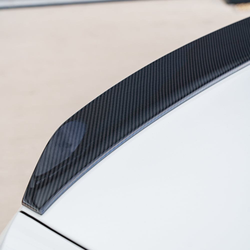 BMW G90 M5 2024 carbon fibre full kit by CT Carbon, including front splitter, side skirts, and rear diffuser, on a sporty saloon.