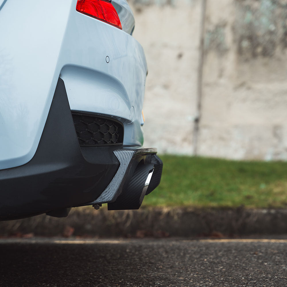 Hyundai i30N carbon fiber exhaust tips by CT Carbon, showing sleek, black finish and exhaust outlet design on a modern car.