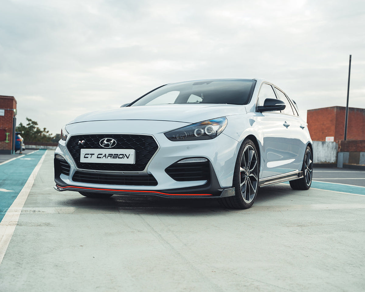 Hyundai i30N front carbon fiber splitter by CT Design, showing the sleek aerodynamic component on the vehicle's front bumper.