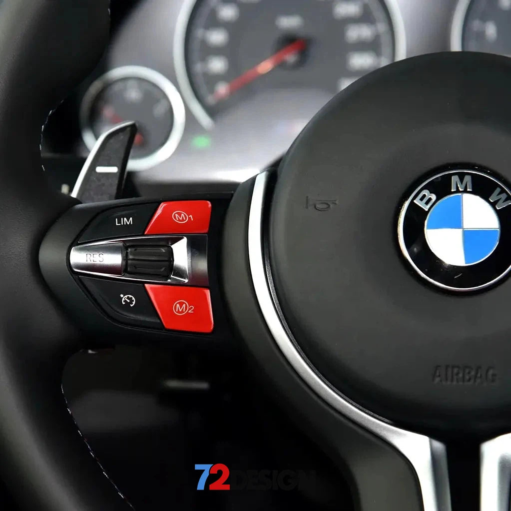 BMW M steering wheel buttons in red from 72Design, interior trim accessory, shown on sleek black steering wheel.
