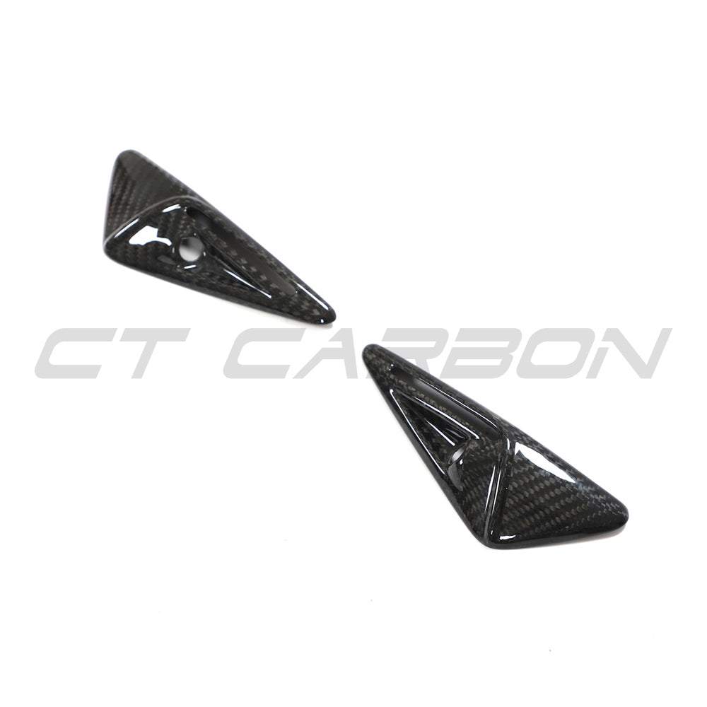 Tesla Model 3 2017-2023 carbon fiber side camera cover by CT Carbon, close-up view of sleek, textured automotive accessory.