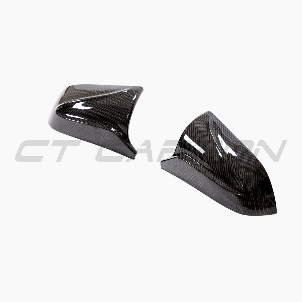 Tesla Model 3 2017+ carbon fiber mirror covers by CT Carbon, V2 accessories, close-up view of sleek, textured carbon fiber finish.