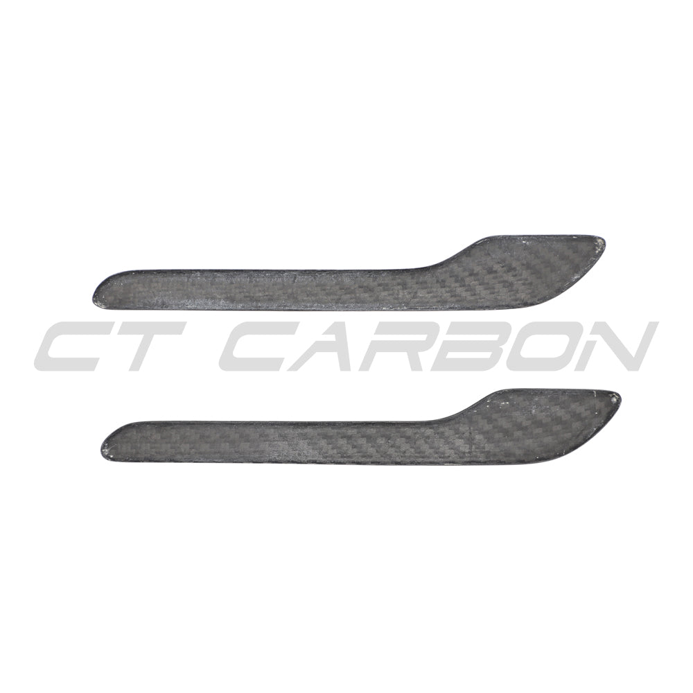 Tesla Model 3 and Y 2017+ carbon fibre handle covers by CT Carbon, close-up of sleek, textured black car interior accessories.