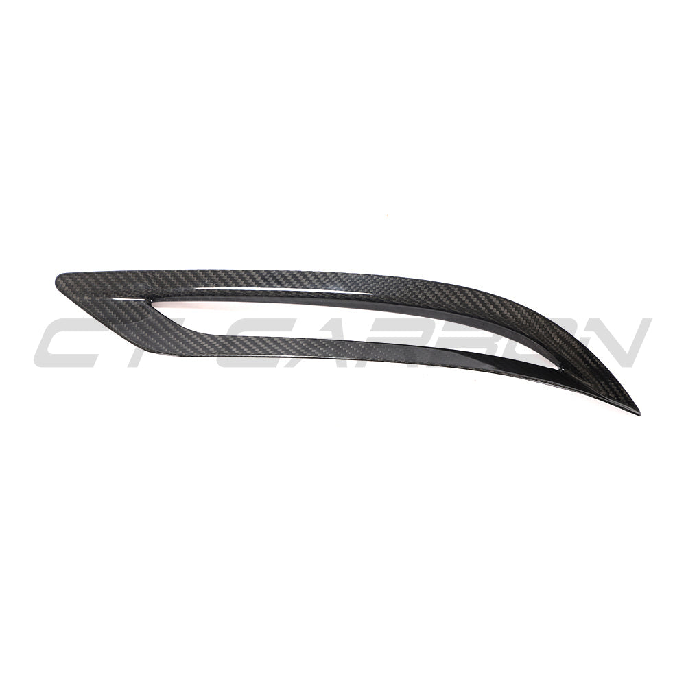 Tesla Model 3 2017-2023 carbon fiber rear reflector cover by CT Carbon, close-up view of sleek, textured car accessory.