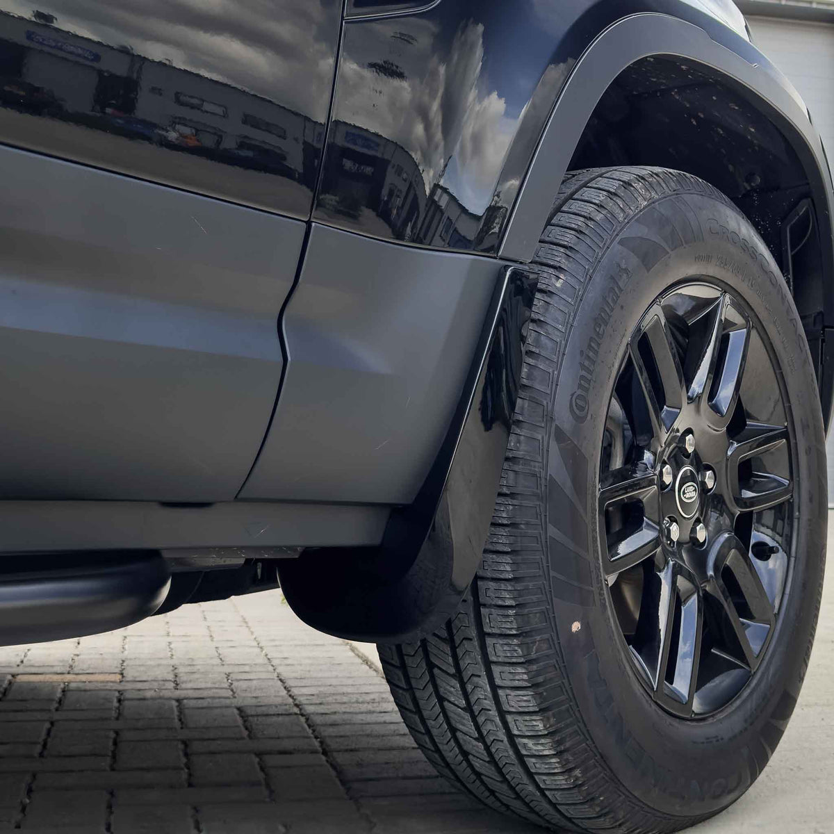 Gloss black mud flaps for Land Rover Defender L663 110 and 90 by CT Carbon, durable accessories for vehicle protection.