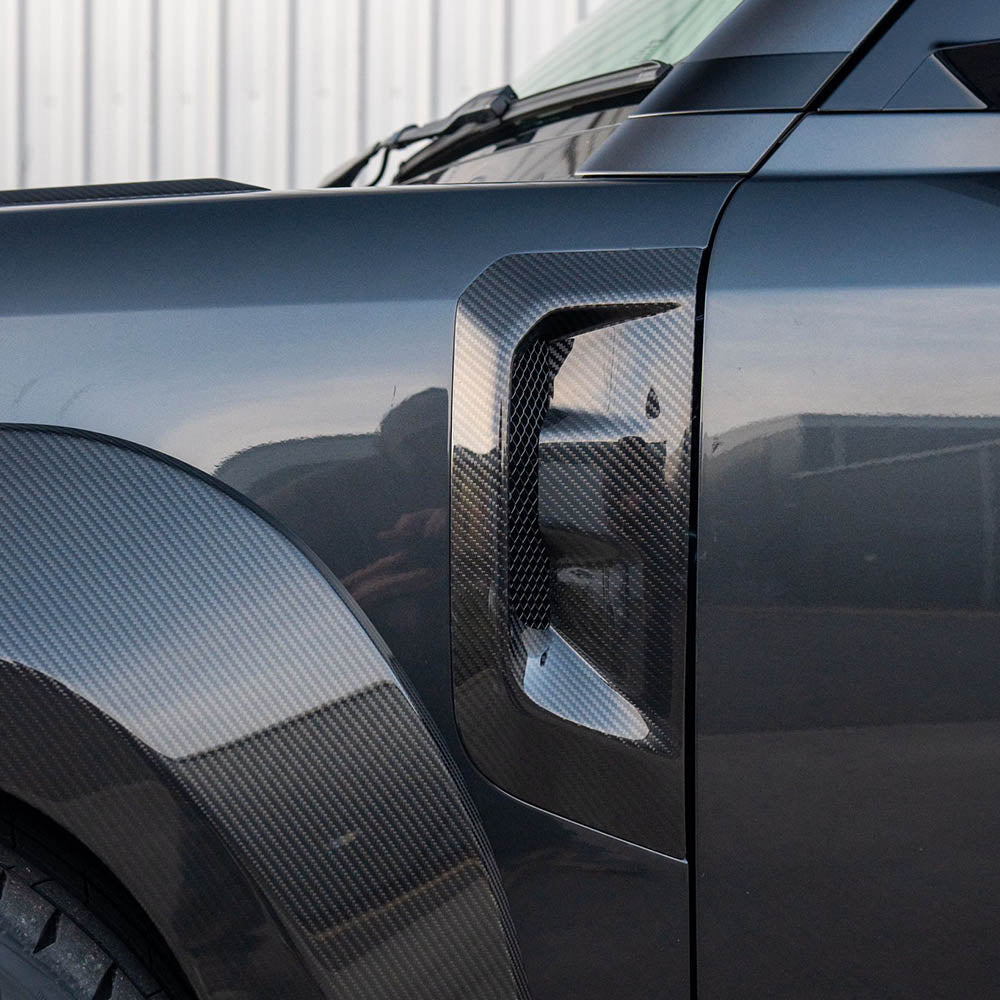 Land Rover Defender L663 110 full carbon fiber wide arch kit by CT Design, showcasing lightweight, durable carbon fiber arches on the vehicle.