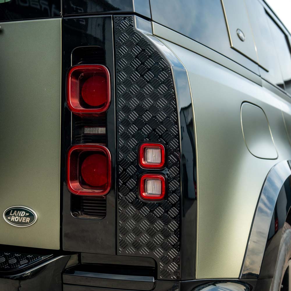 Land Rover Defender L663 110 gloss black anti-scratch trim set by CT Carbon, showing close-up of sleek, durable exterior trim components.