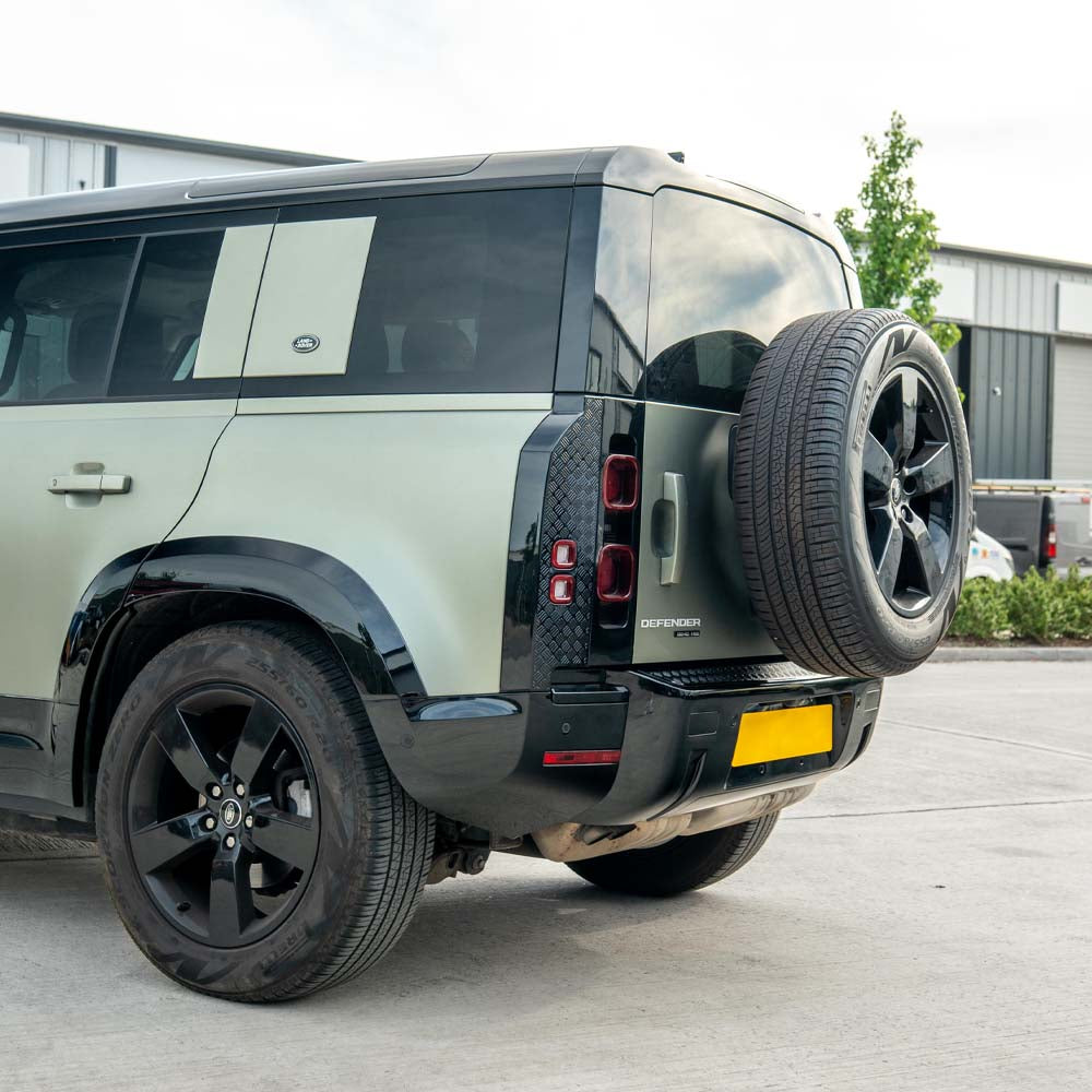 Gloss black anti-scratch trim set for Land Rover Defender L663 110 by CT Carbon, shown on vehicle exterior.