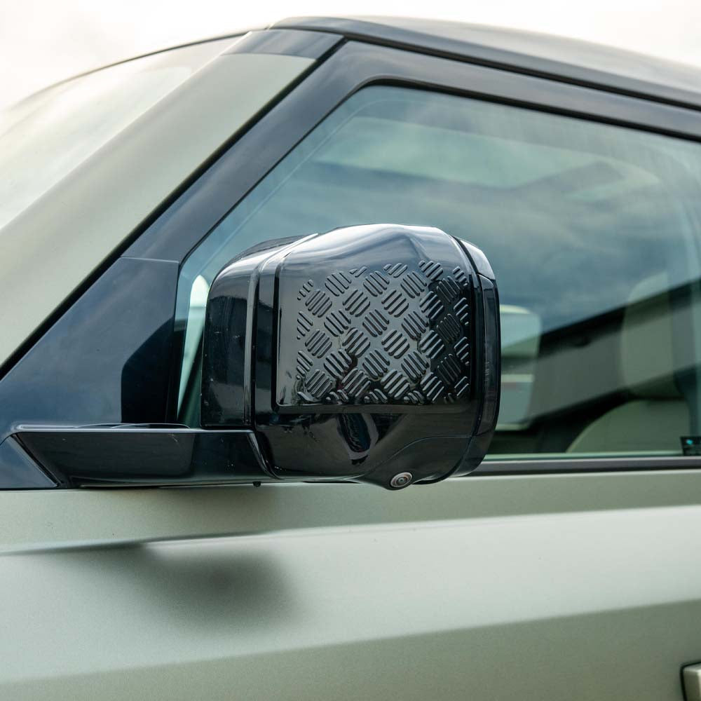 Land Rover Defender L663 110 gloss black anti-scratch trim set by CT Carbon, shown on vehicle with close-up of trim details.