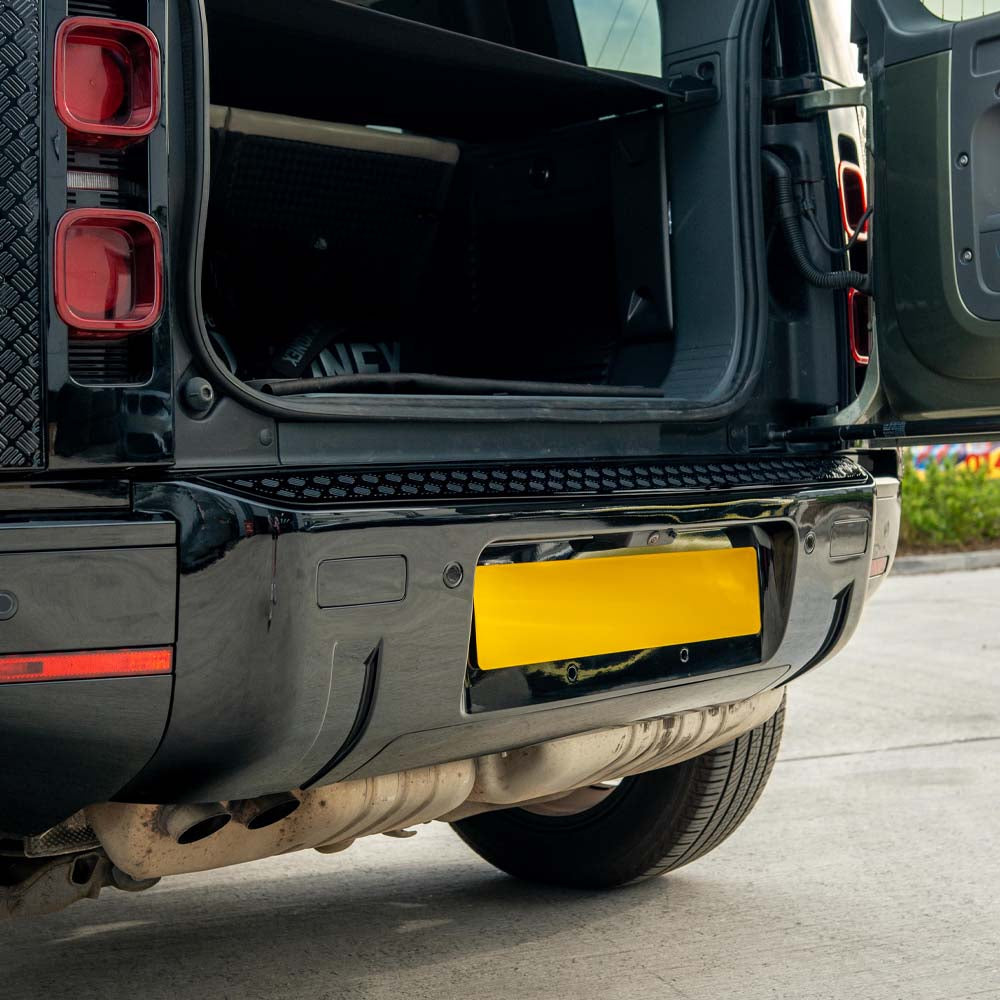 Gloss black anti-scratch trim set for Land Rover Defender L663 110 by CT Carbon, shown on vehicle exterior.