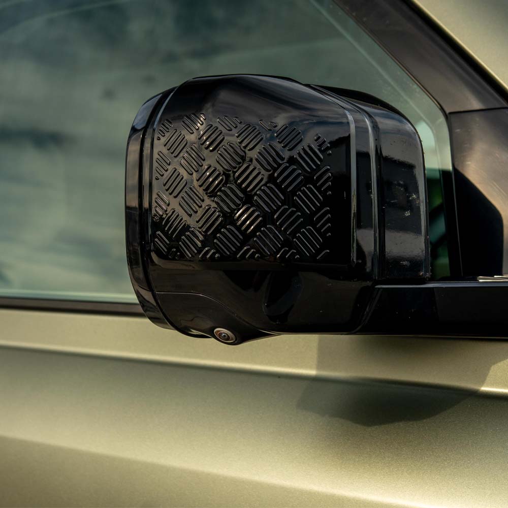 Land Rover Defender L663 110 gloss black anti-scratch trim set by CT Carbon, shown installed on vehicle with close-up of trim details.