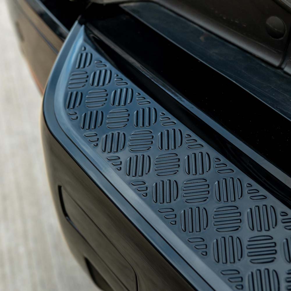 Land Rover Defender L663 110 gloss black anti-scratch trim set by CT Carbon, shown on vehicle with sleek black finish.