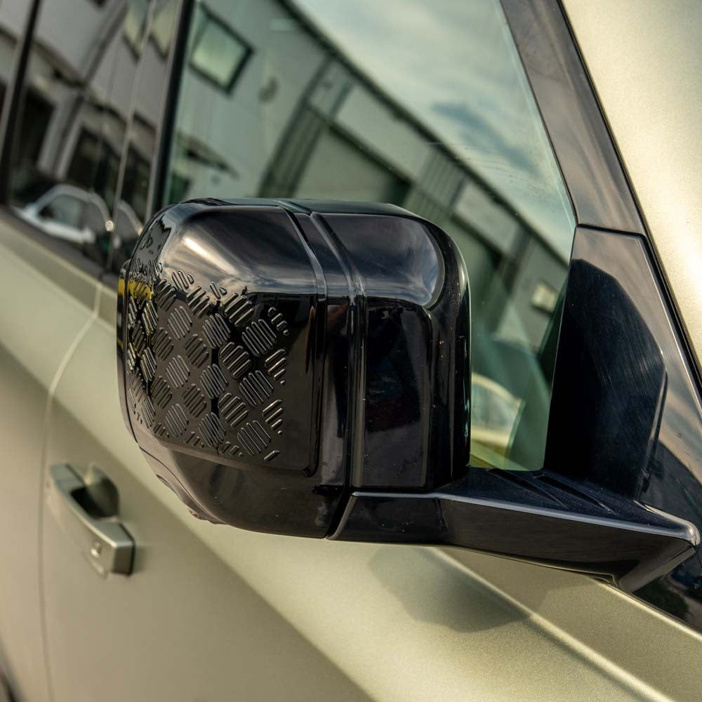 CT Carbon gloss black anti-scratch trim set for Land Rover Defender L663 110, shown installed on vehicle exterior.