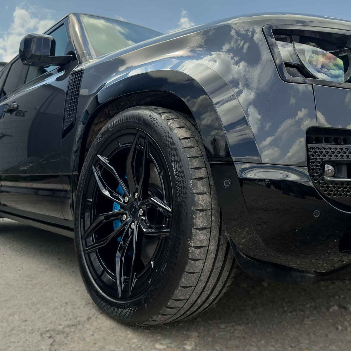 Gloss black wide arch fenders for Land Rover Defender L663 110 by CT Carbon, showcasing sleek, durable exterior accessories.