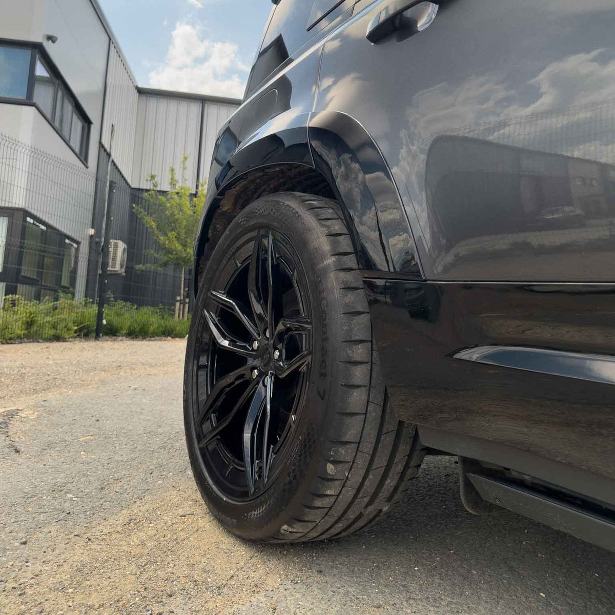 Set of CT Carbon gloss black wide arch fenders for Land Rover Defender L663 110, enhancing off-road style and protection.