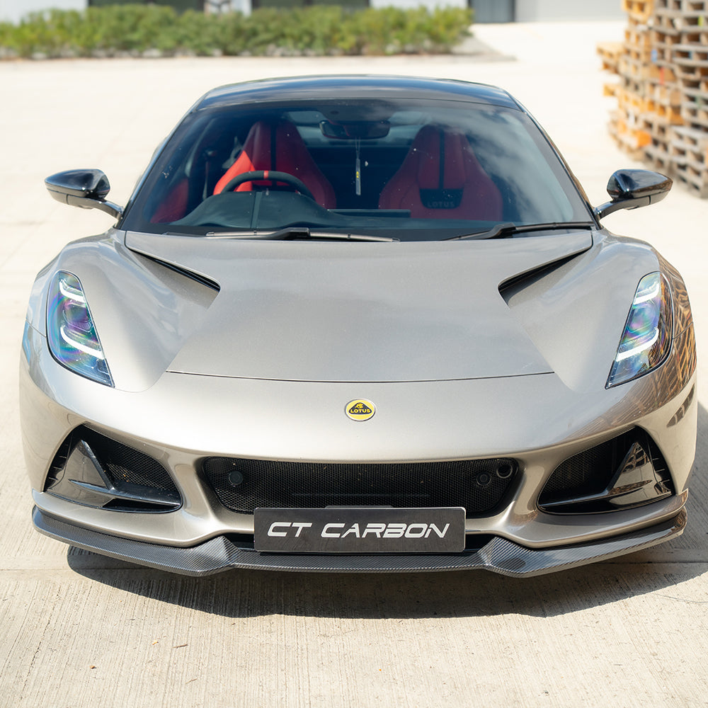 Carbon fiber front splitter for Lotus Emira by CT Design, showcasing aerodynamic styling and lightweight construction.