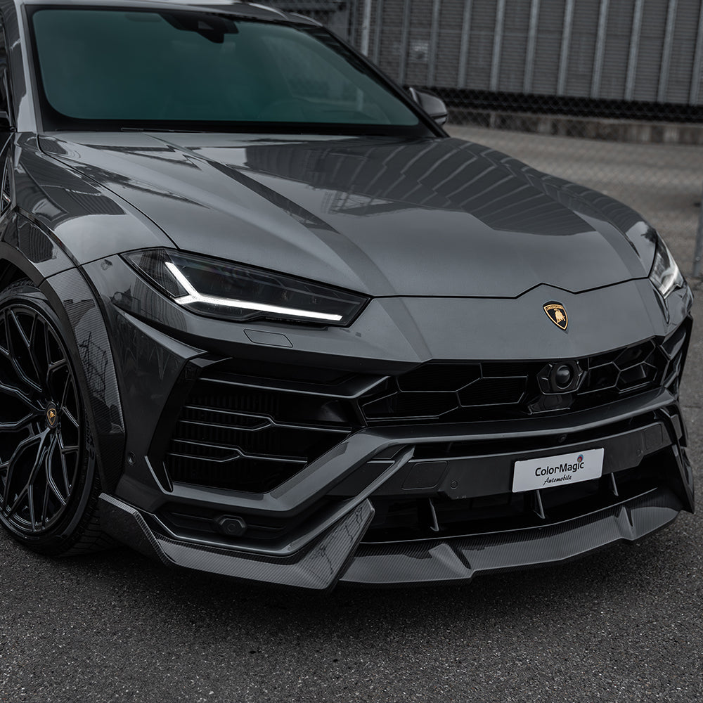 Lamborghini Urus carbon fibre splitter by CT Carbon, close-up of sleek aerodynamic car front part with textured carbon fiber finish.