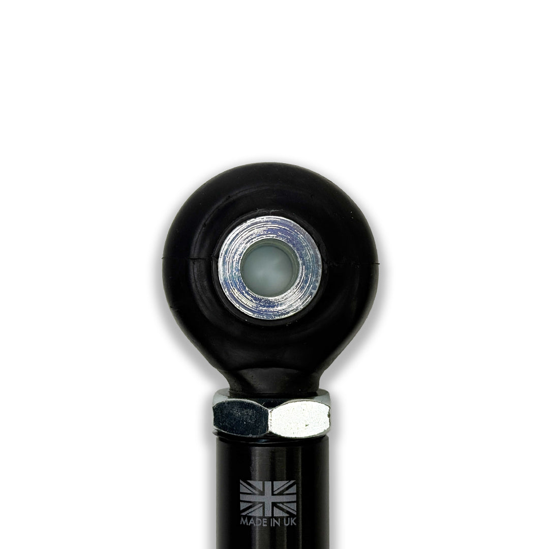 M18 rod end rubber boot for spherical bearings, suspension and alignment part by XC3 Engineering, shown on a vehicle suspension component
