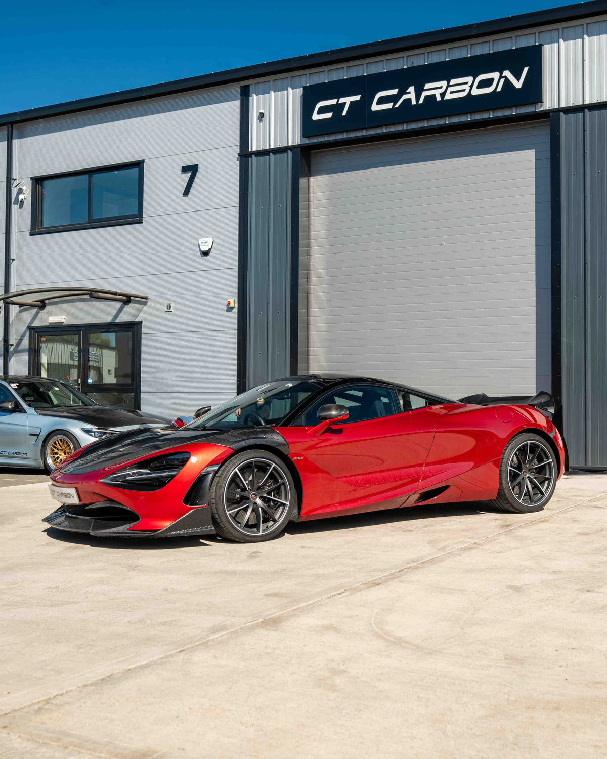 Carbon fiber splitter for McLaren 720S by CT Carbon, showing the sleek, aerodynamic design and textured finish.