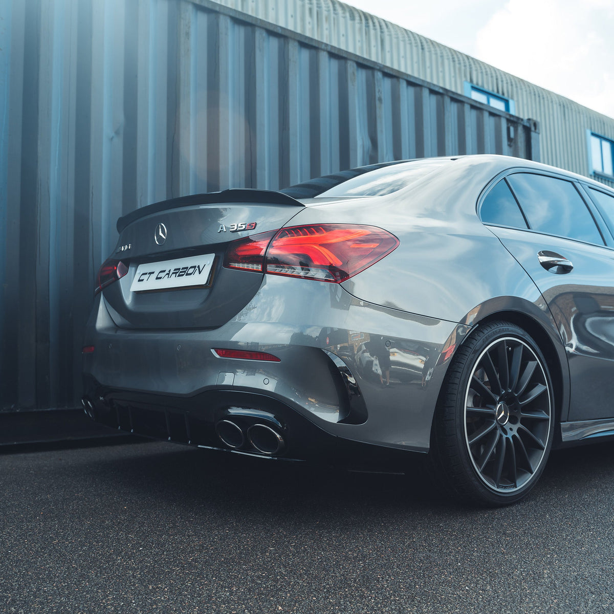 Mercedes A-Class A35 V177 gloss black rear bumper corners, CT Carbon accessories, close-up view of the sleek, finished car detail.