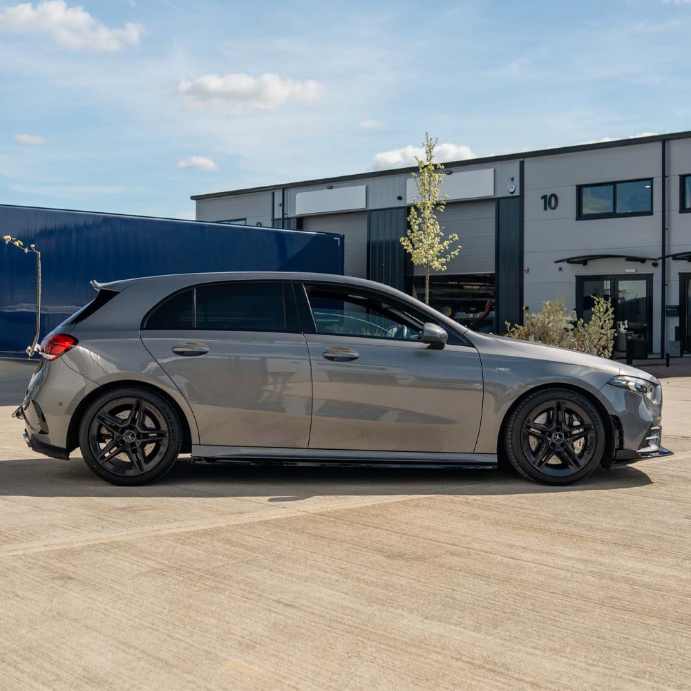 Mercedes A-Class W177 V177 2018+ CT Carbon gloss black side skirts installed on the vehicle's lower sides.