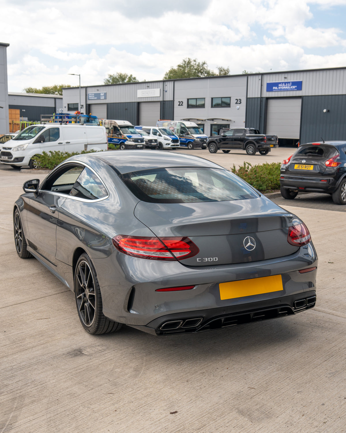Mercedes C-Class C43 W205 coupe gloss black rear bumper trim accessory by CT Carbon, shown installed on the vehicle.