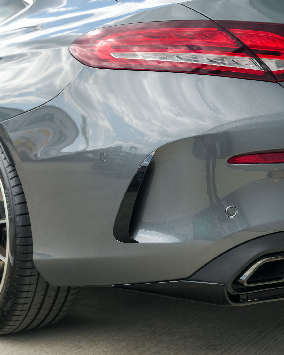 Gloss black rear bumper trim for Mercedes C-Class and C43 W205 coupe by CT Carbon, shown on the vehicle.