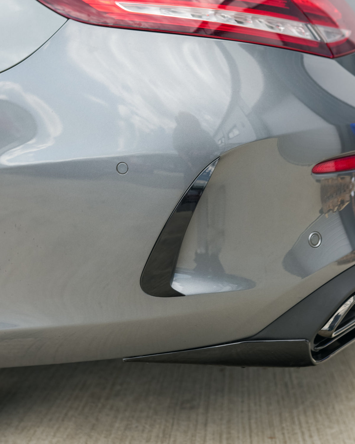 Mercedes C-Class C43 W205 coupe gloss black rear bumper trim accessory by CT Carbon, shown on the vehicle.