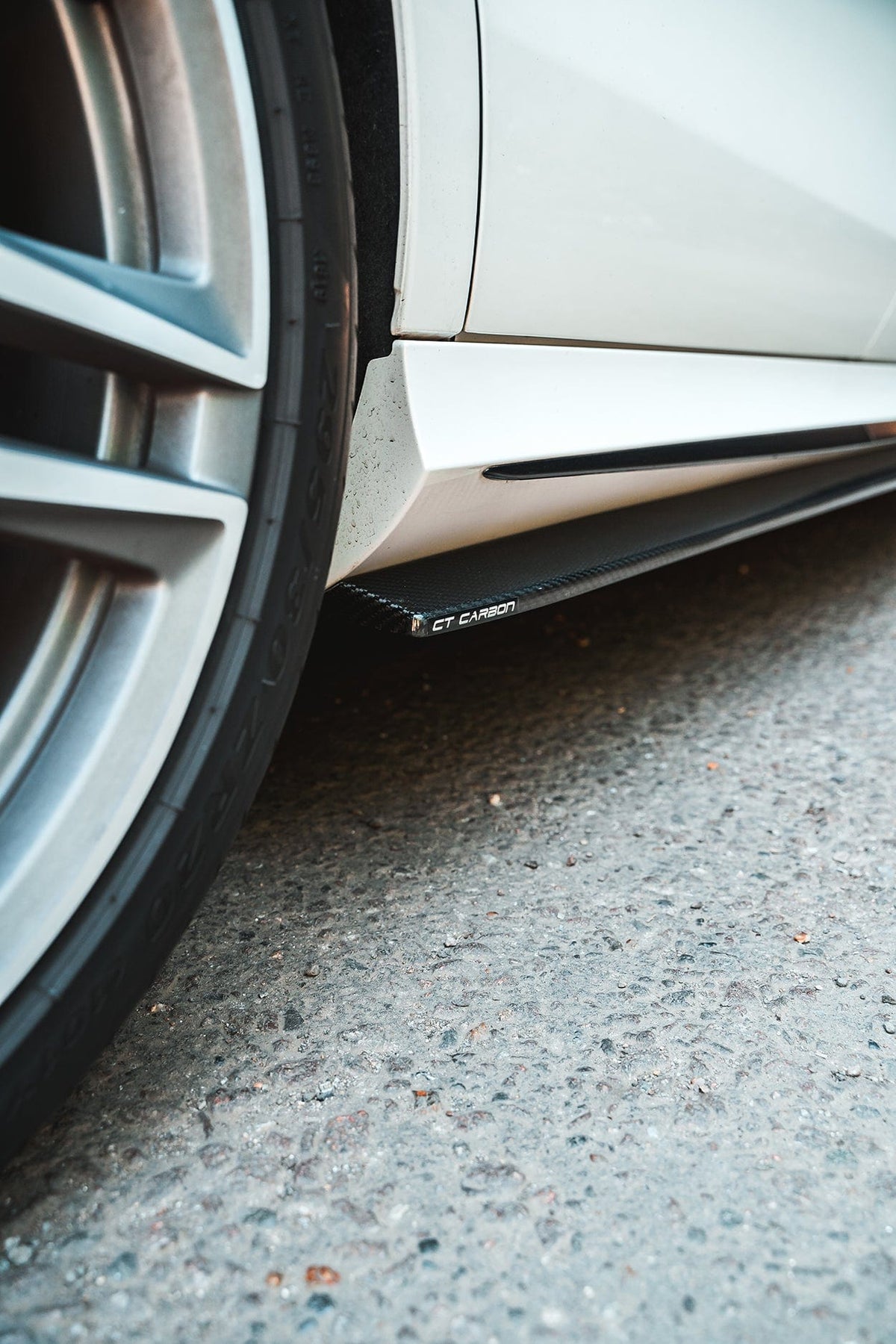 Mercedes E63 W213 2018-2020 carbon fibre side skirts by CT Design, showing sleek aerodynamic design on the vehicle's side.