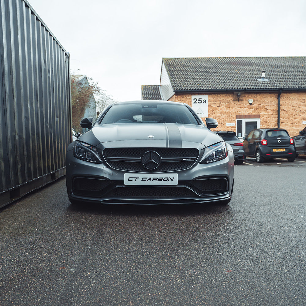 Mercedes W205 C63 coupe 2015-2018 CT Carbon gloss black splitter installed on front bumper, enhancing sporty appearance and aerodynamics.