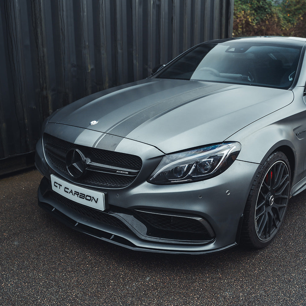 Mercedes W205 C63 Coupe 2015-2018 CT Carbon gloss black splitter installed on front bumper, enhancing sporty appearance.