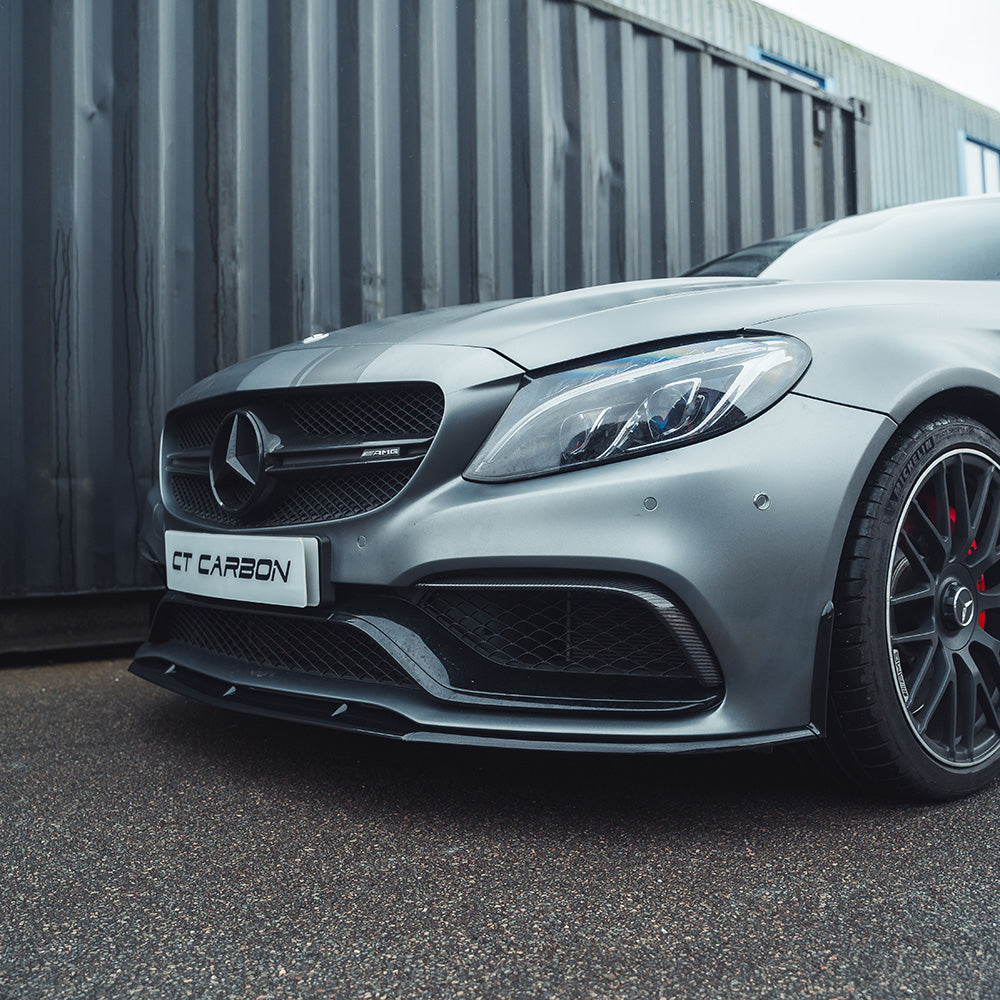 Mercedes W205 C63 Coupe 2015-2018 CT Carbon gloss black splitter front view, showcasing aerodynamic design and sleek finish.