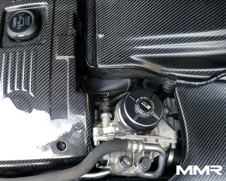 MMX Performance billet oil filter housing for BMW N20, N52, N54, N55, S55 engine bay trim, installed on car engine.