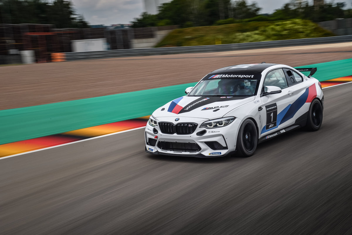 Genuine BMW Motorsport M2 CS Racing front splitter installed on a BMW M2 CS Racing vehicle for improved aerodynamics.