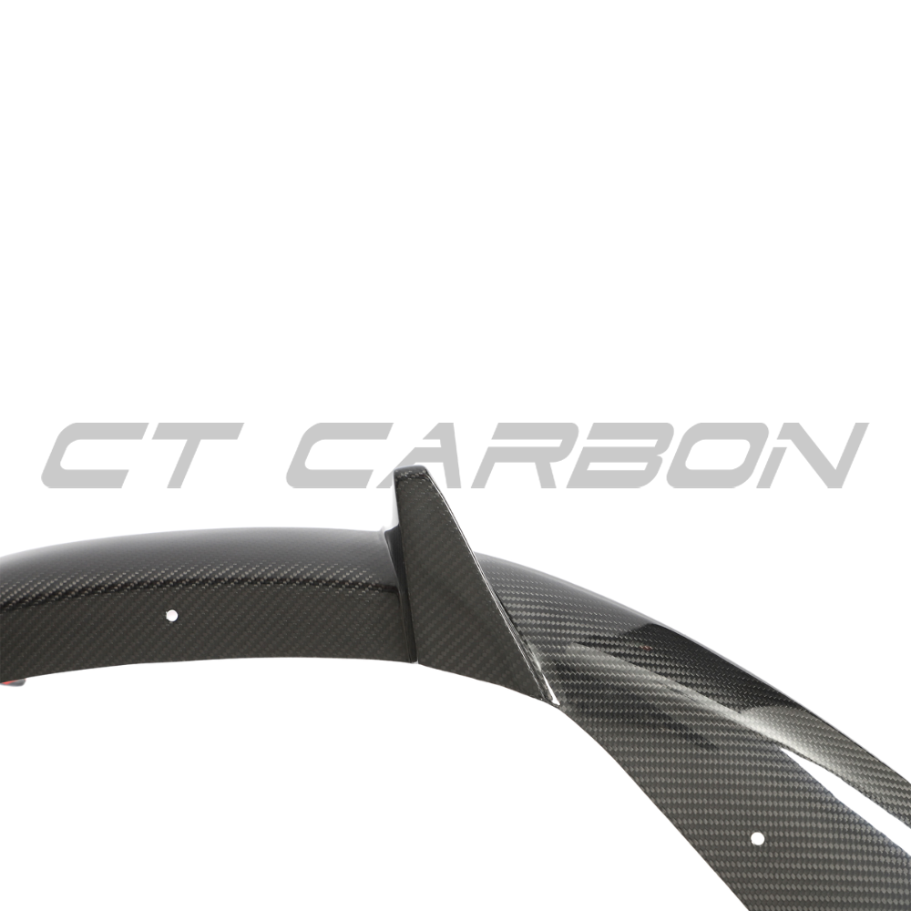 Porsche 911 992 Carrera carbon fiber diffuser by CT Design, showcasing sleek aerodynamic design and textured carbon fiber surface.