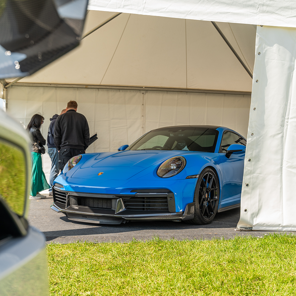 Porsche 911 (992) Turbo S carbon fiber front splitter by CT Design, showing sleek aerodynamic design and detailed fiber pattern.