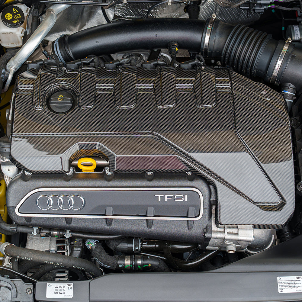 Carbon fiber engine cover for Audi RS3 8Y 2020+ by CT Carbon, showcasing sleek, lightweight engine accessory with detailed weave pattern.