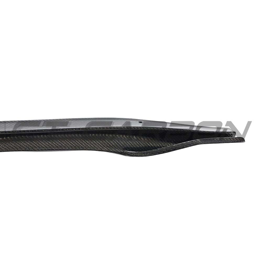 Tesla Model 3 2017-2023 carbon fibre side skirts by CT Carbon, featuring sleek, aerodynamic design installed along the vehicle's sides.
