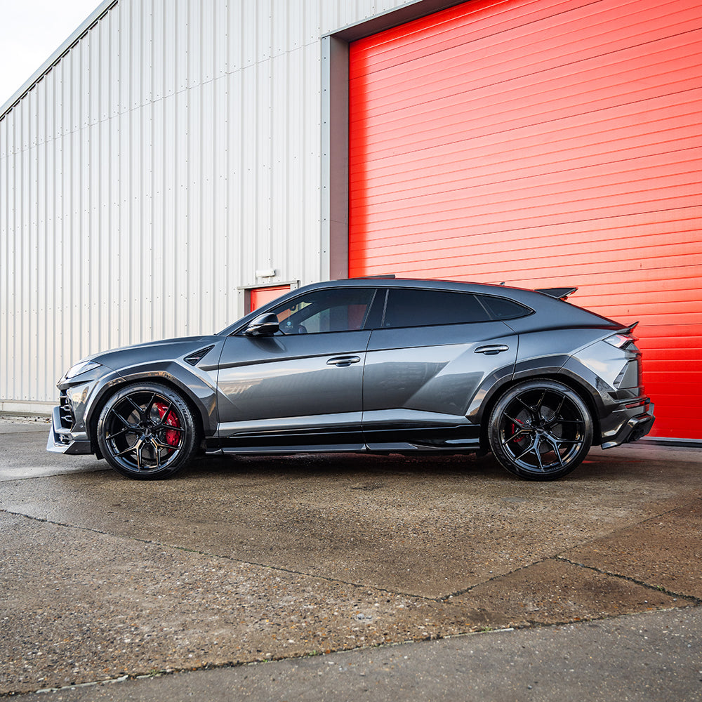 Lamborghini Urus carbon fibre side skirts by CT Carbon, sleek and aerodynamic car accessories on a white background.