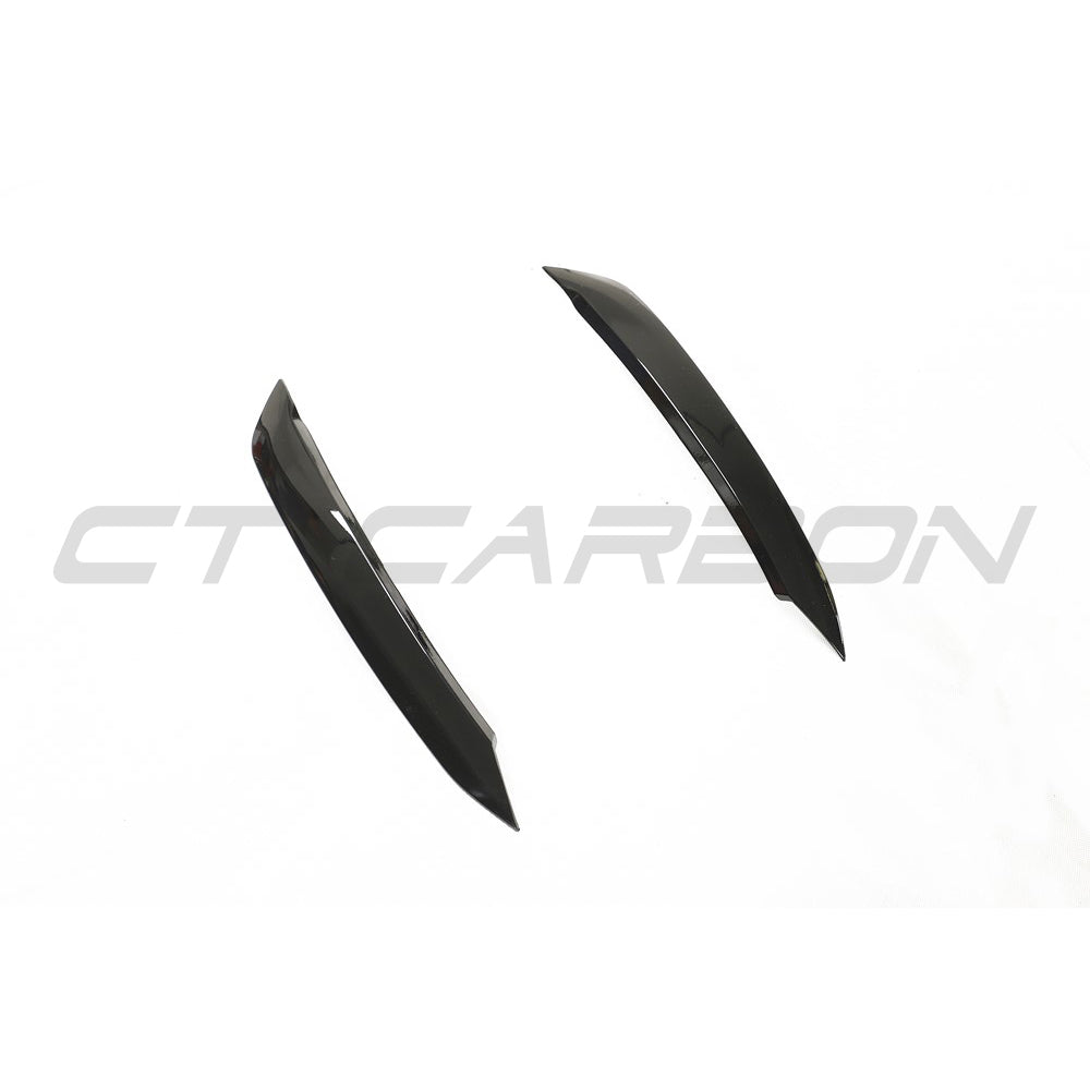 Volkswagen Polo MK6 gloss black headlight eyebrows accessory by CT Carbon installed on the vehicle's front headlights.